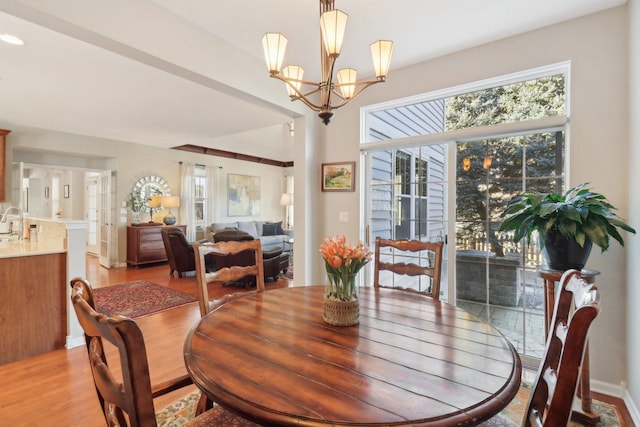 dining area with a chandelier and light wood-type flooring