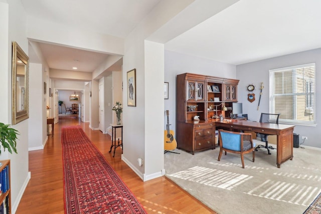 home office with baseboards and light wood finished floors