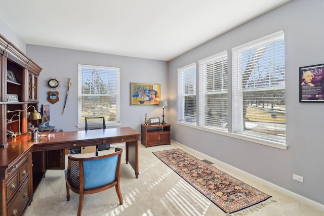 office featuring baseboards and light colored carpet