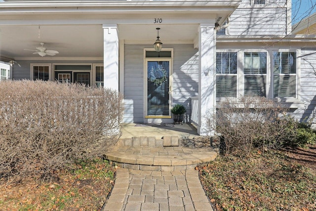 property entrance featuring ceiling fan and a porch