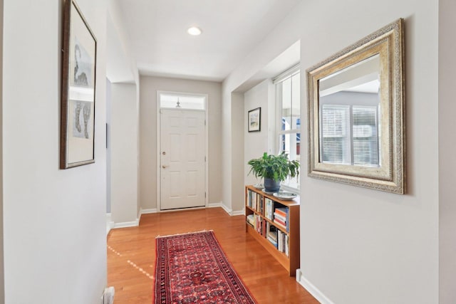 doorway with recessed lighting, baseboards, and wood finished floors