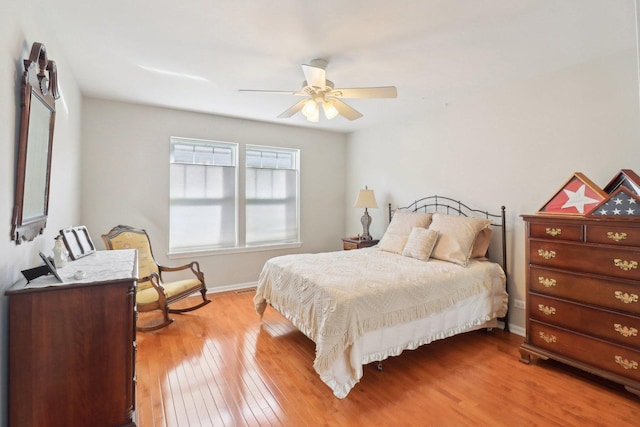 bedroom with wood-type flooring, visible vents, baseboards, and a ceiling fan