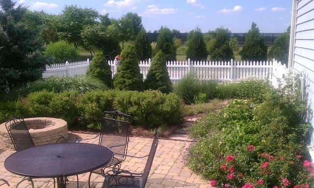 view of patio featuring outdoor dining area and fence