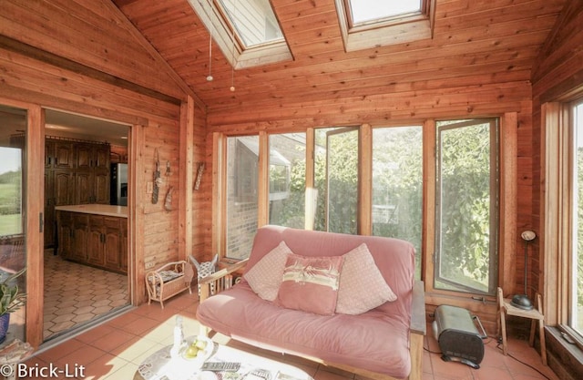 sunroom / solarium featuring vaulted ceiling with skylight and wooden ceiling