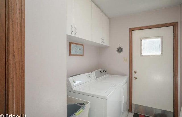 clothes washing area featuring washer and dryer, cabinet space, and a sink