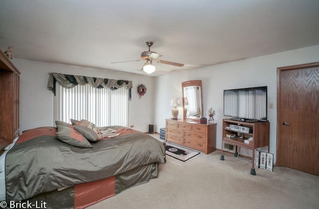 carpeted bedroom featuring ceiling fan and a closet