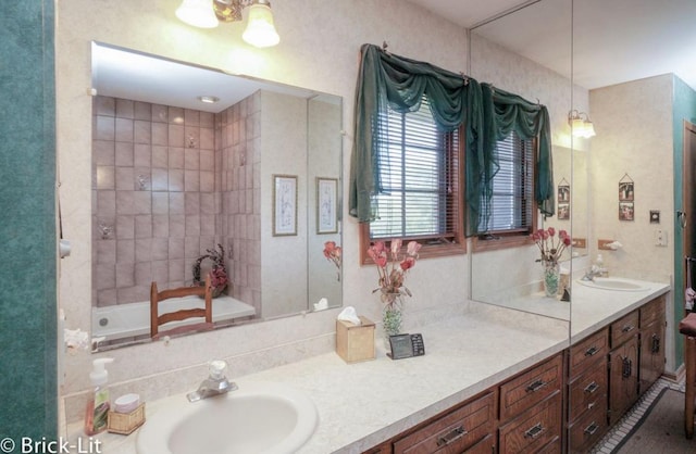 full bathroom featuring a washtub and vanity