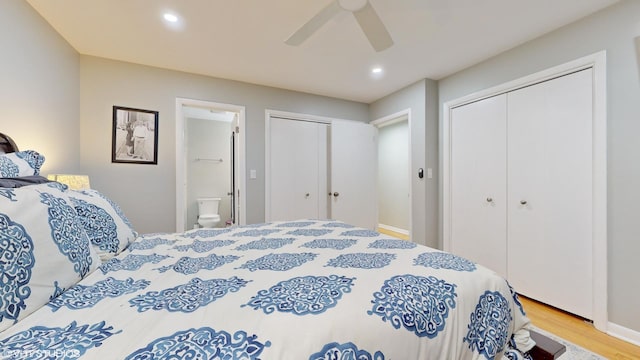 bedroom with recessed lighting, ceiling fan, ensuite bathroom, and wood finished floors