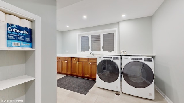 clothes washing area featuring recessed lighting, baseboards, cabinet space, and washing machine and clothes dryer