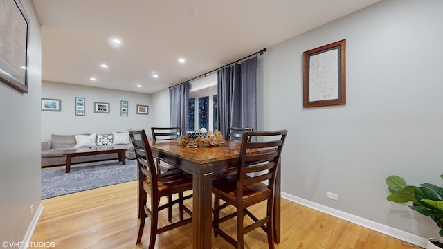 dining room featuring baseboards, recessed lighting, and light wood-style floors