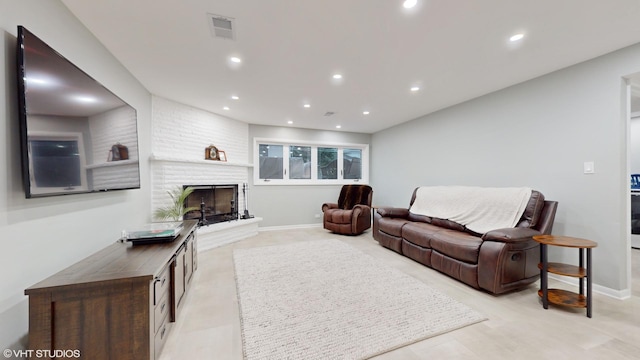 living area with baseboards, a fireplace, visible vents, and recessed lighting