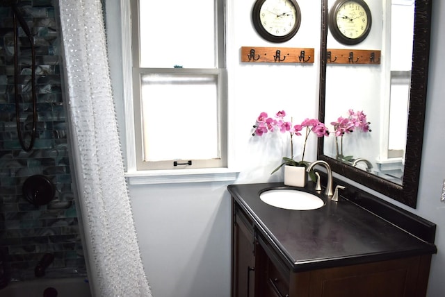 full bath with a shower with curtain, vanity, and a healthy amount of sunlight