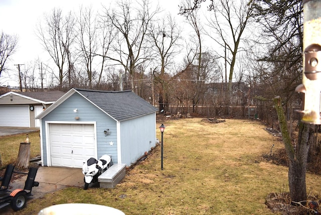 detached garage featuring fence