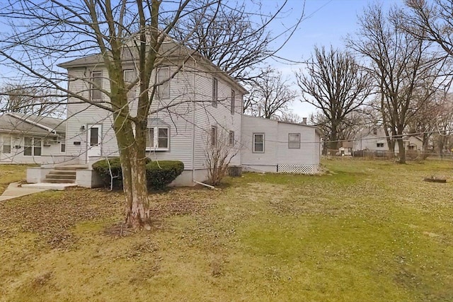 view of side of property featuring a yard