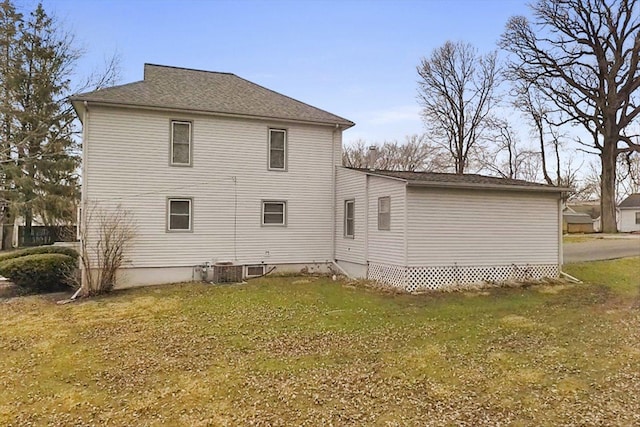 rear view of house featuring a lawn