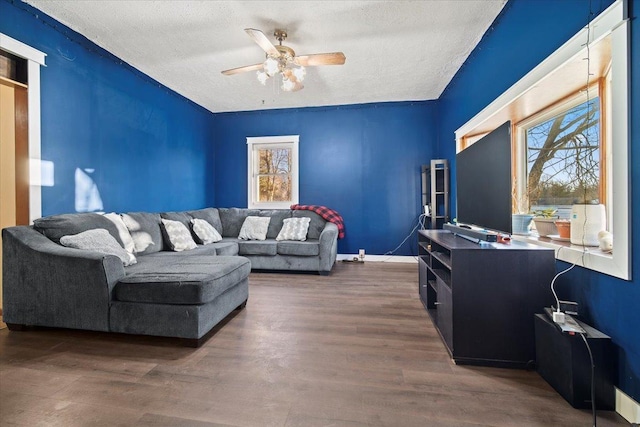 living area featuring ceiling fan, a textured ceiling, and wood finished floors