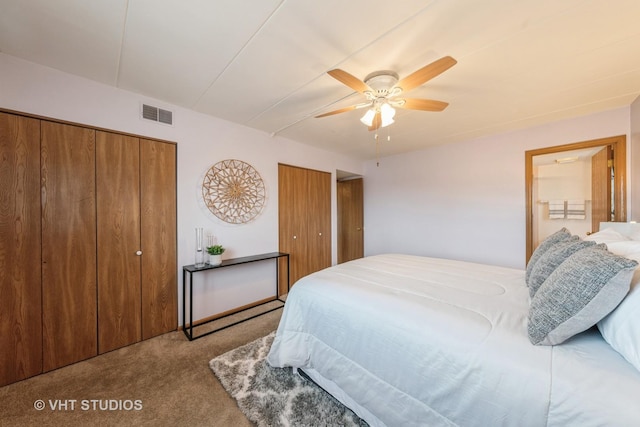 bedroom featuring ceiling fan, carpet floors, two closets, and visible vents