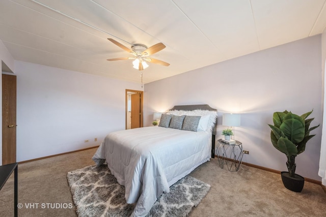 carpeted bedroom with ceiling fan and baseboards