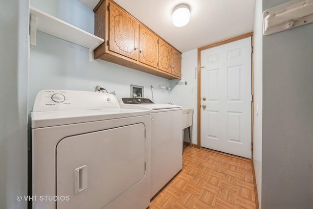 laundry room with cabinet space and washing machine and dryer