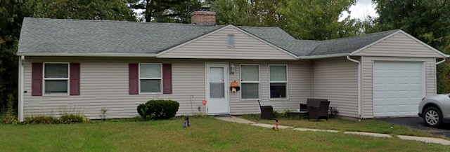 view of front of property with a chimney, a shingled roof, a garage, driveway, and a front lawn