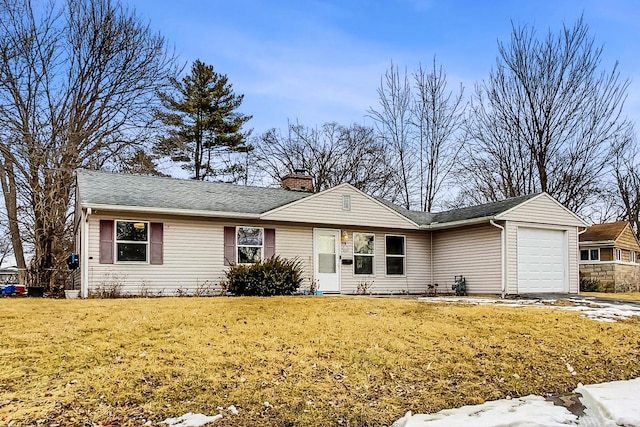 ranch-style home with a chimney, an attached garage, and a front yard