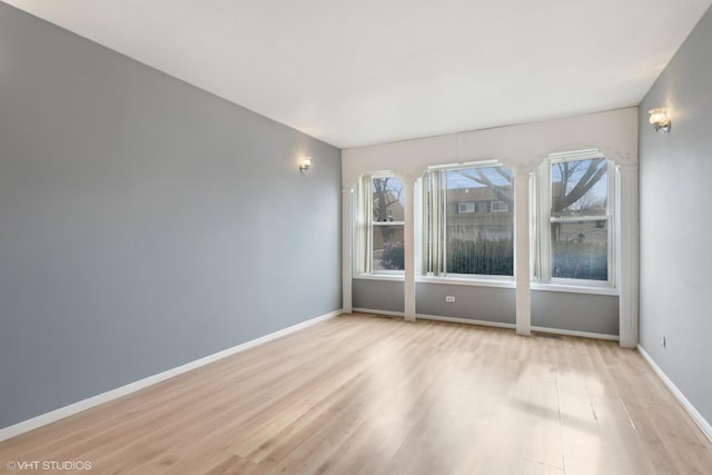 empty room with light hardwood / wood-style flooring