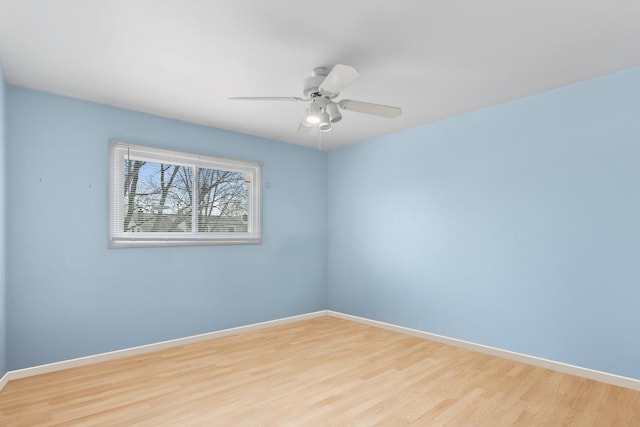 spare room featuring light wood-type flooring and ceiling fan