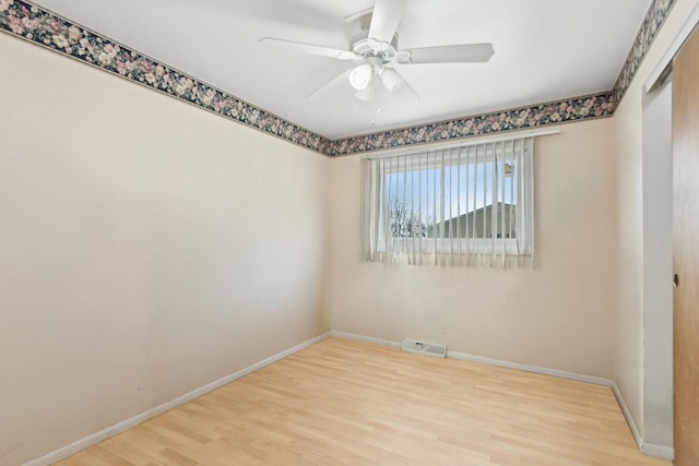 empty room featuring hardwood / wood-style flooring and ceiling fan