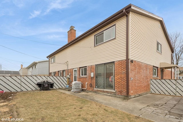 rear view of property featuring a yard, a patio area, and central AC unit