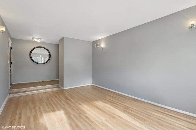 spare room with light wood-type flooring