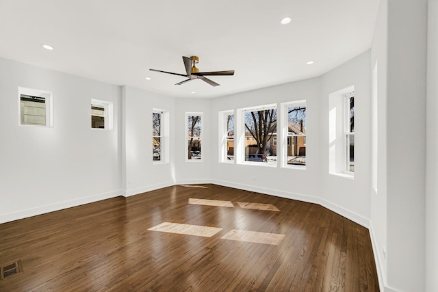 empty room featuring baseboards, visible vents, ceiling fan, dark wood-type flooring, and recessed lighting