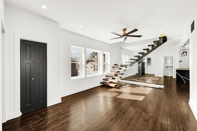 interior space with dark wood-style floors, recessed lighting, ceiling fan, baseboards, and stairs