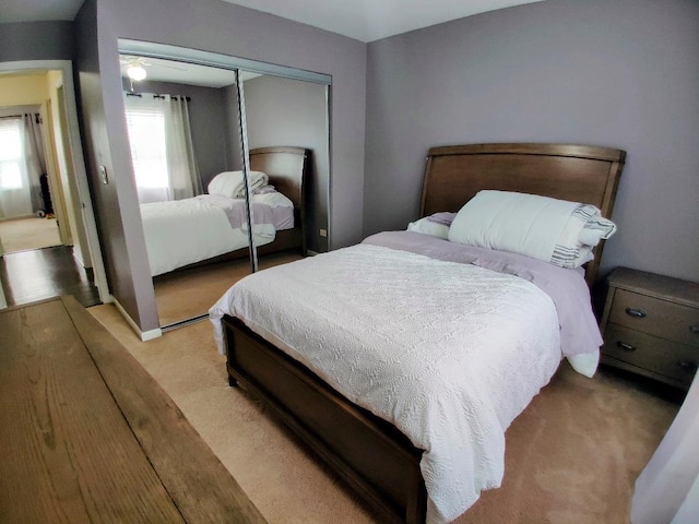 bedroom with a closet and light colored carpet