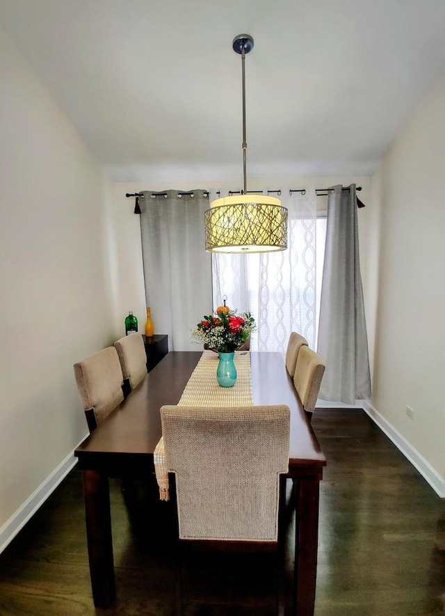 dining area with wood finished floors and baseboards