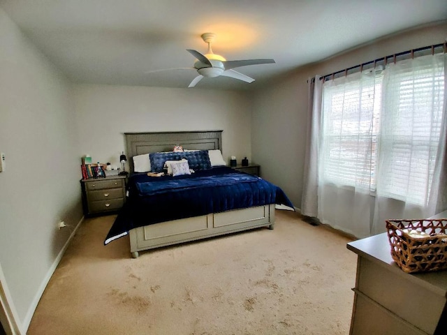 carpeted bedroom featuring baseboards and ceiling fan