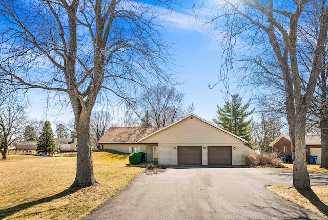 view of home's exterior with a yard, driveway, and an attached garage