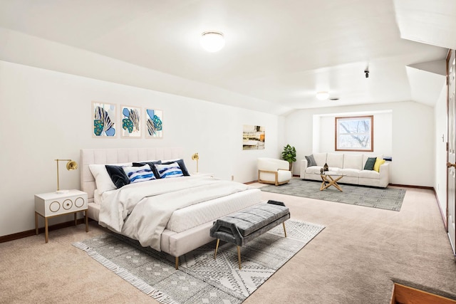 carpeted bedroom featuring baseboards and lofted ceiling