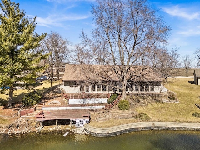 back of property featuring a deck with water view