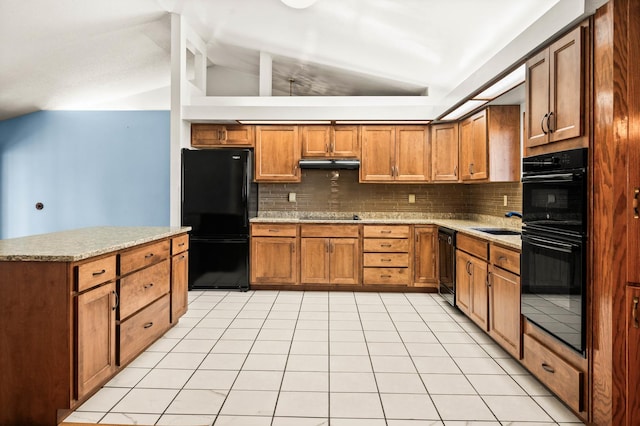 kitchen featuring under cabinet range hood, brown cabinets, black appliances, and vaulted ceiling