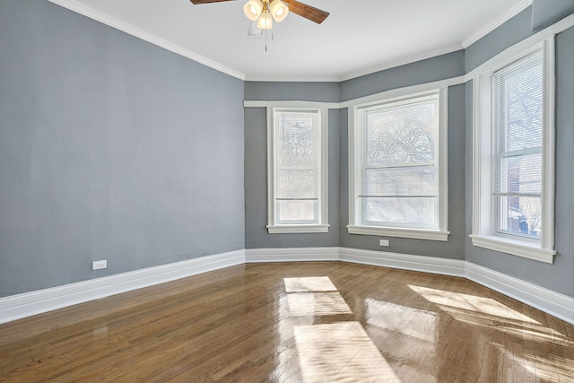 unfurnished room featuring ornamental molding, baseboards, a wealth of natural light, and ceiling fan