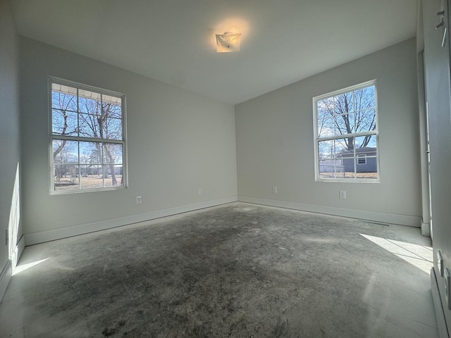 unfurnished bedroom featuring multiple windows and baseboards