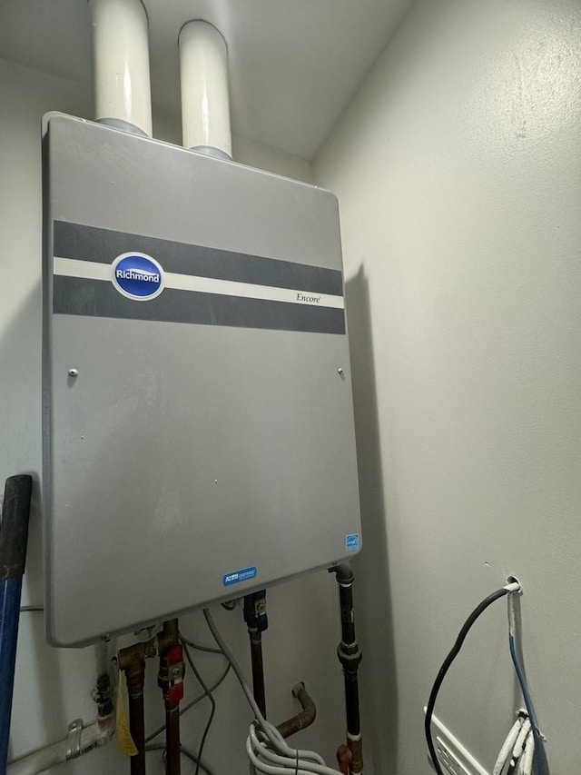 utility room featuring tankless water heater