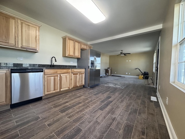 kitchen featuring light brown cabinetry, appliances with stainless steel finishes, a ceiling fan, and wood tiled floor