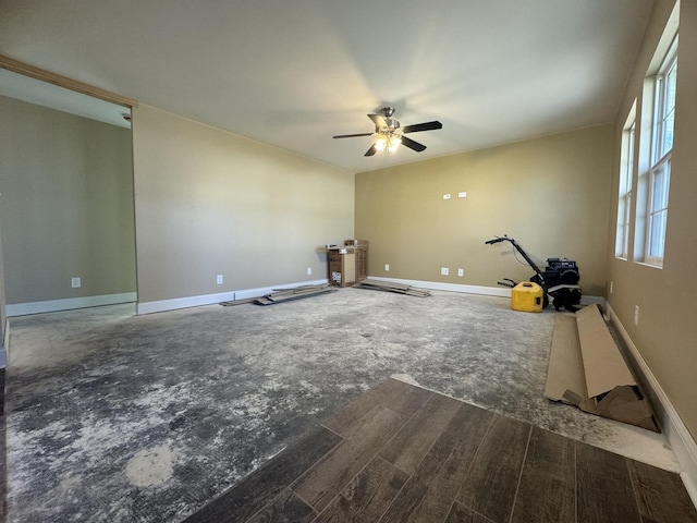 interior space featuring a ceiling fan and baseboards