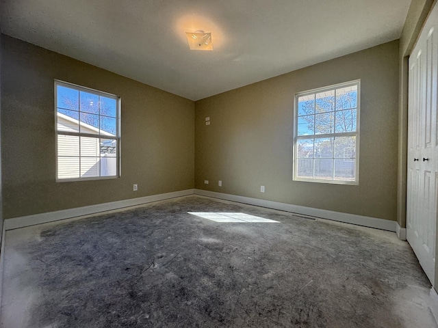 unfurnished bedroom with baseboards and a closet