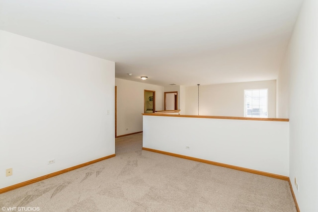 carpeted empty room with baseboards