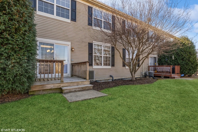 exterior space with a deck, central air condition unit, and a front yard