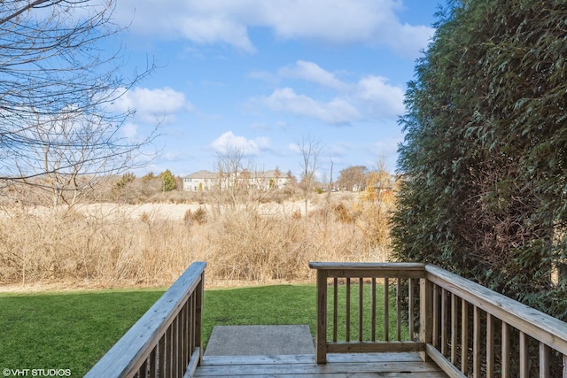 wooden deck featuring a yard