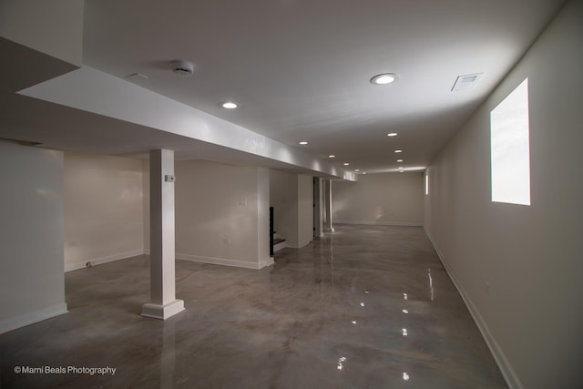 finished below grade area with recessed lighting, visible vents, and baseboards