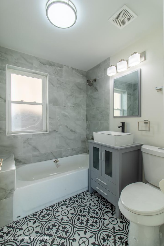 full bathroom with visible vents, toilet, tile patterned flooring, bathtub / shower combination, and vanity